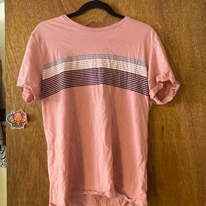 large pink shirt with gray, white and black stripes across chest